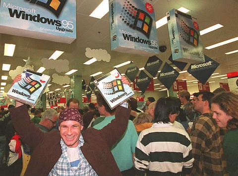 SYDNEY, AUSTRALIA - AUGUST 24: Mikol Furneaux(L) waves two packages of Windows 95 software in the first store in Australia to sell the product at midnight 24 August. Microsoft hopes to sell between 20 and 30 million copies of the software world wide by the end of 1995. AFP PHOTO (Photo credit should read TORSTEN BLACKWOOD/AFP/Getty Images)
