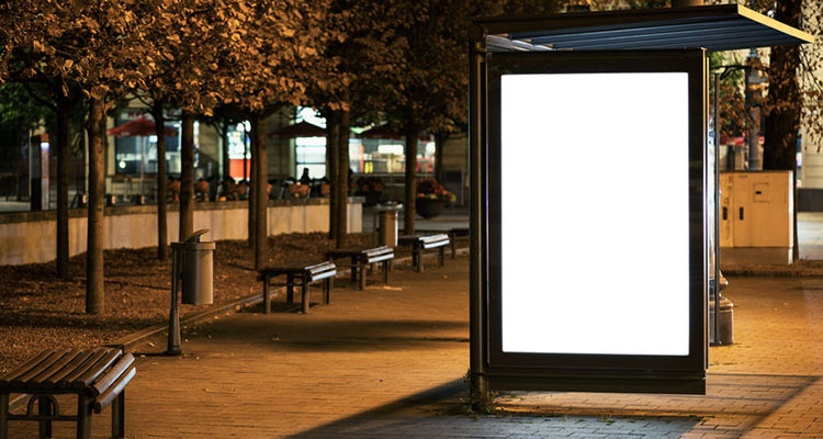 48054369 - blank bus stop advertising billboard in the city at night.