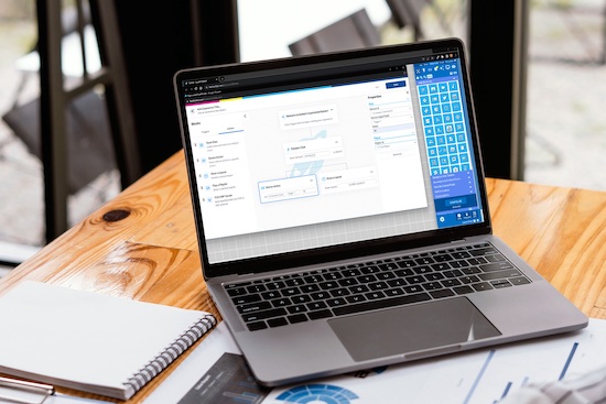 Side view of contemporary workplace with laptop computer, notebook, coffee cup and stationery on wooden table. clipping path.